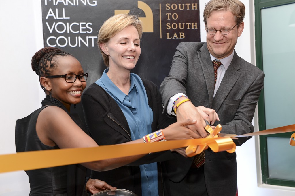 Guest of honour, Sida's, Anders Rönquist, cutting the ribbon together with Omidyar Network's [name] and Ushahidi CEO Juliana Rotich.